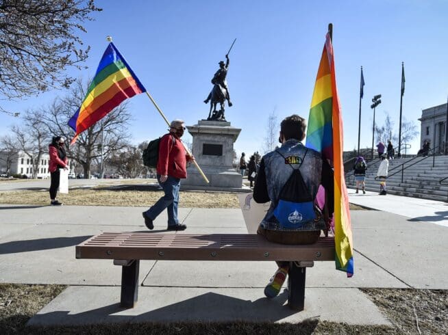 Demonstrators gather on the step of the Montana State Capitol protesting anti-LGBTQ+ legislation on Monday, March 15, 2021, in Helena, Mont. (Thom Bridge/Independent Record via AP)